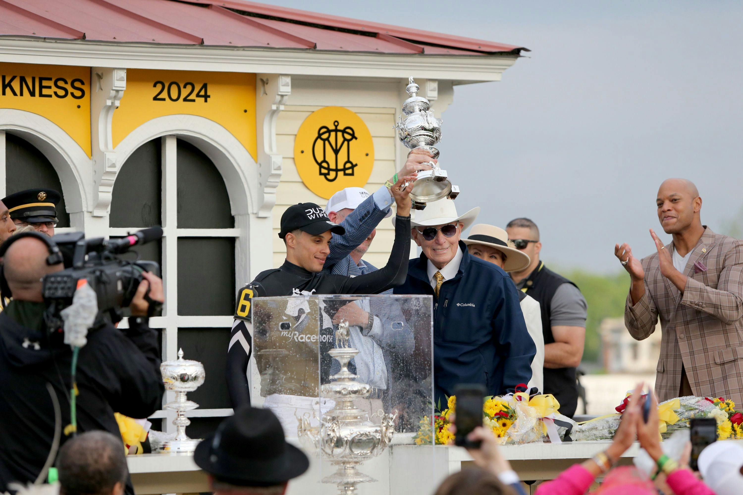 Torres and Lukas hoist the trophy after the Preakness