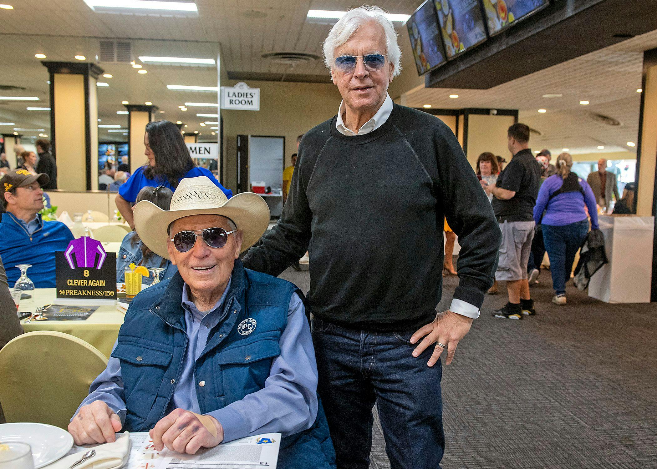 Legendary trainers D. Wayne Lukas (seated) and Bob Baffert (standing)