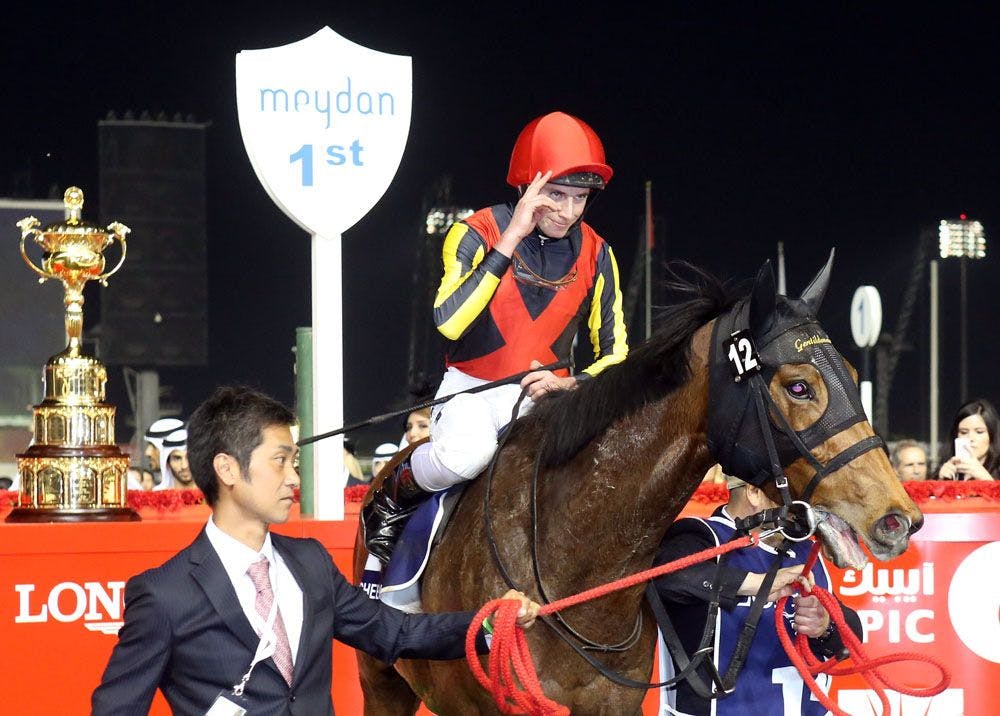 Ryan Moore salutes after Gentildonna's victory in the 2014 Dubai Sheema Classic (G1)